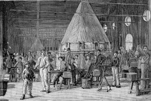 Eine Schwarz-Weiß-Zeichnung einer Gruppe von Menschen, die in einer 19. Jahrhundert-Fabrik arbeiten, wobei einige Werkzeuge halten und verschiedene Gegenstände herumliegen, und Text unten lesen "19. Jahrhundert Schmiede."