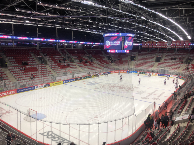 Eishockeyspiel in einer großen Arena zwischen den St. Louis Blues und den Detroit Red Wings, mit Zuschauern auf den Sitzen und am Rand der Eisfläche.