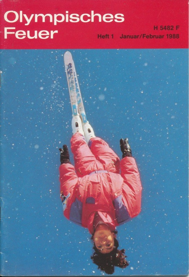 Buchumschlag mit dem Titel "Olympische Spiele Feuer - Heft 1 - Januar/Februar 1988" mit einem Skifahrer in der Luft in einem Ski-Anzug mit entschlossener Miene.