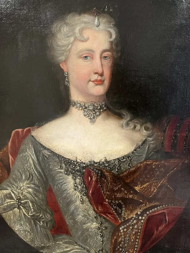 Ein Bild einer Frau in einem roten Kleid, die mutmaßlich Königin Victoria ist, mit dunklem Hintergrund, einem Halsband und frisiertem Haar, die zur Seite blickt und einen würdevollen Ausdruck hat.
